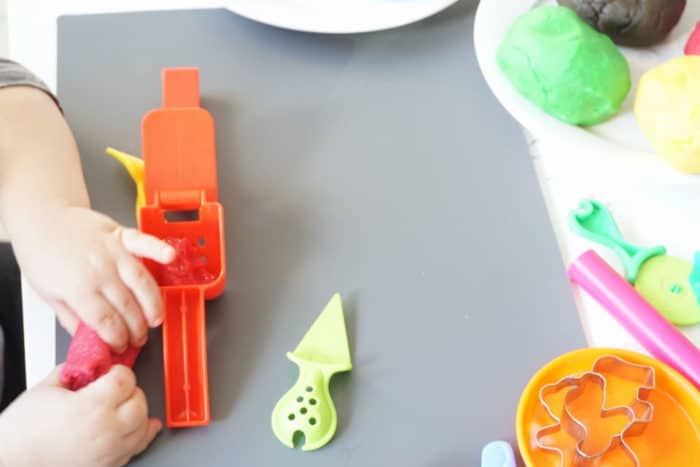 graues Brett mit roter Knoblauchpresse aus Plasik - selbstgemachte Knete ohne Alaun